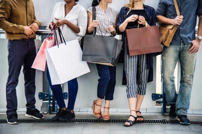 Diverse people holding shopping bags