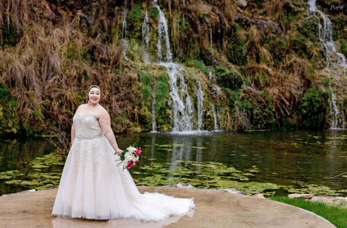 Bride posing in front of waterfall