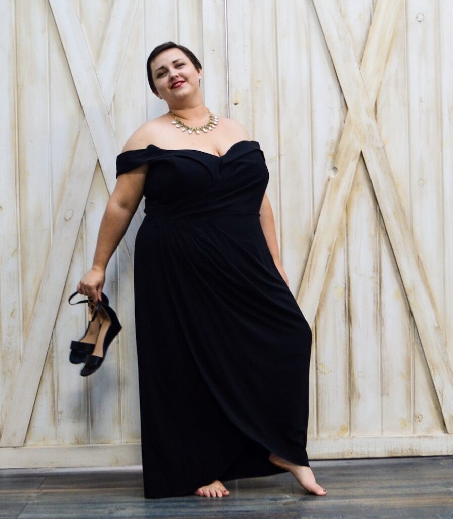 Plus size LGBT model in black holiday dress