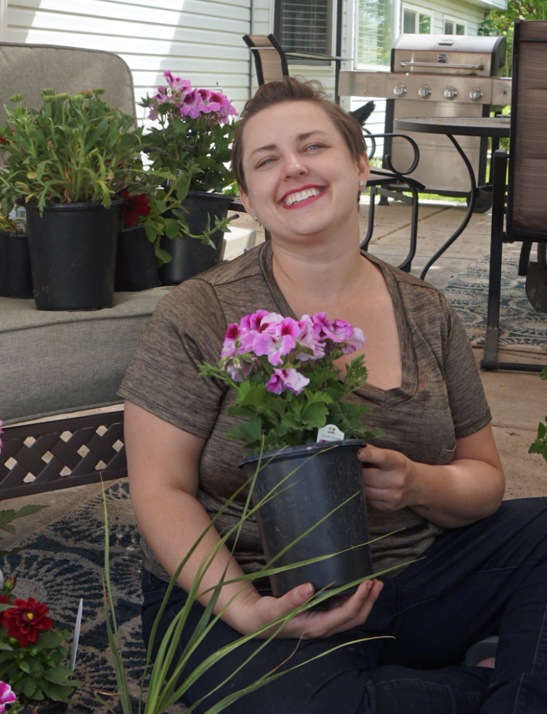 Blogger posing with flowers for container gardening - home improvement project