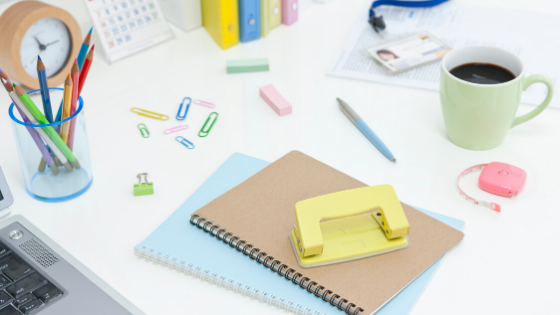 desk with office supplies on it