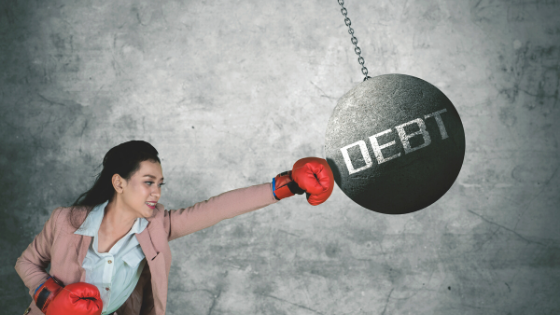 Woman in boxing gloves hitting debt - The 7 Smartest Things I've Done in 2020 