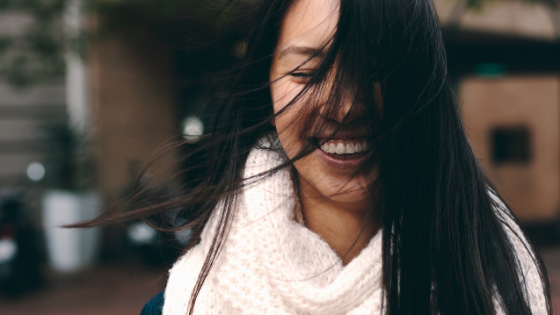 Happy woman smiling wind in her face