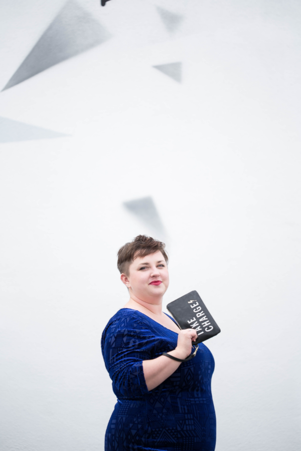 plus size model with purse in blue velvet dress