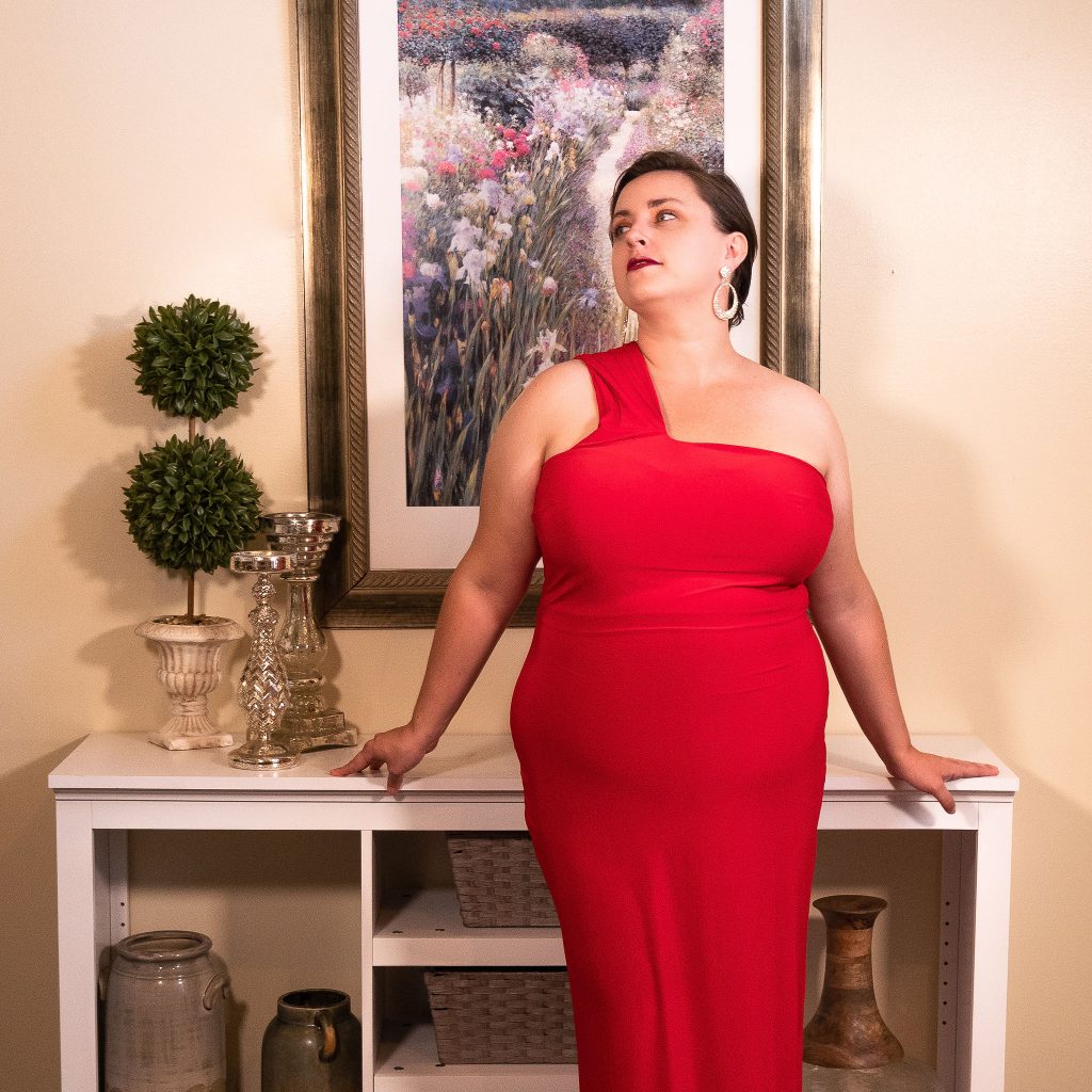 Fashion editorial in living room with gowns and cheese puffs