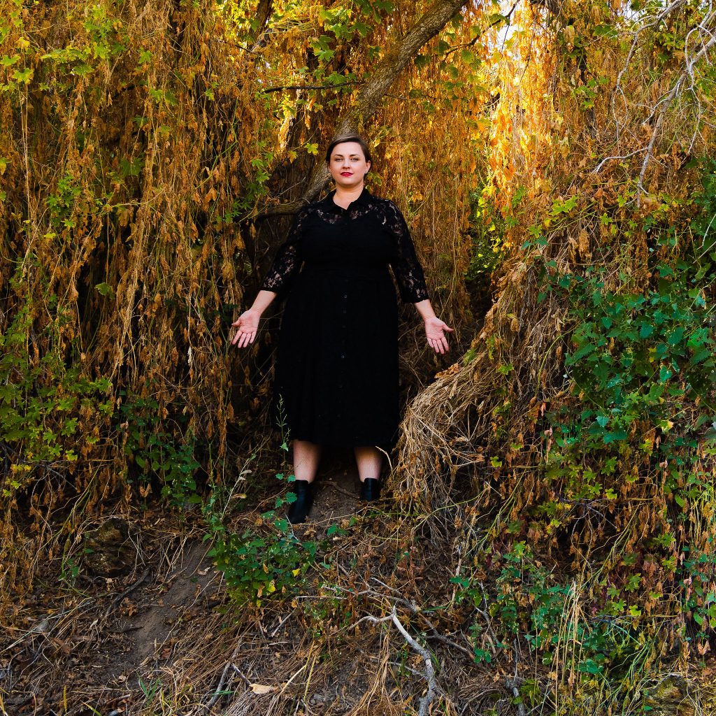 Plus size fall halloween witchy dress in forest with black boots inspired b Sabrina Netflix