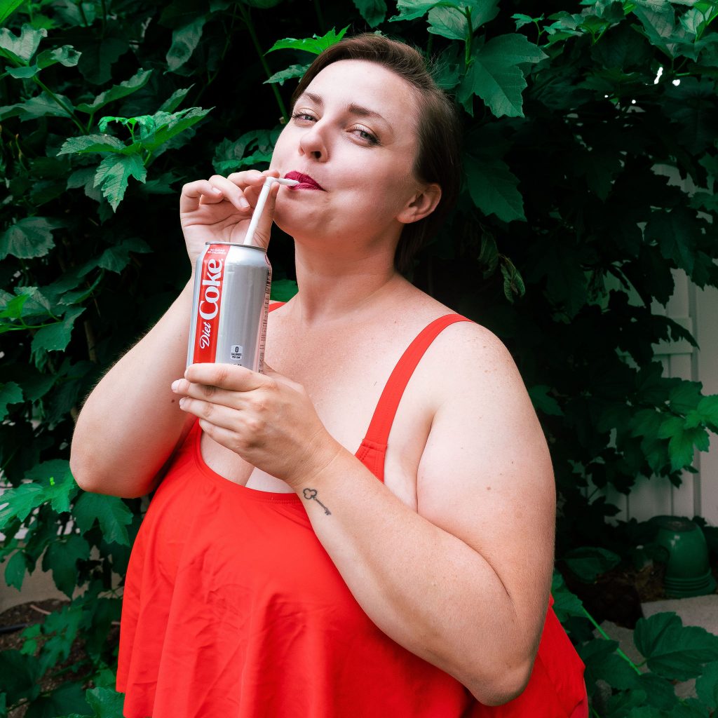 Plus size fashion blogger with Diet Coke in red swimsuit from Amazon