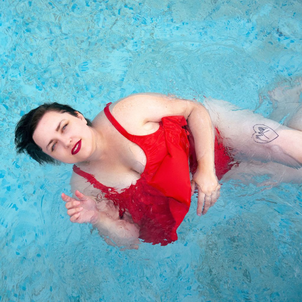 fashion blogger in swimming pool wearing bikini from amazon plus size blogger