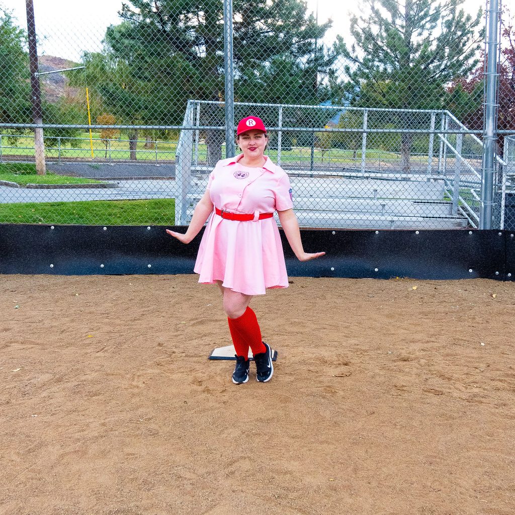 Costume Review - Plus Size a League of Their Own Halloween Costume - blogger posing in pink baseball dress