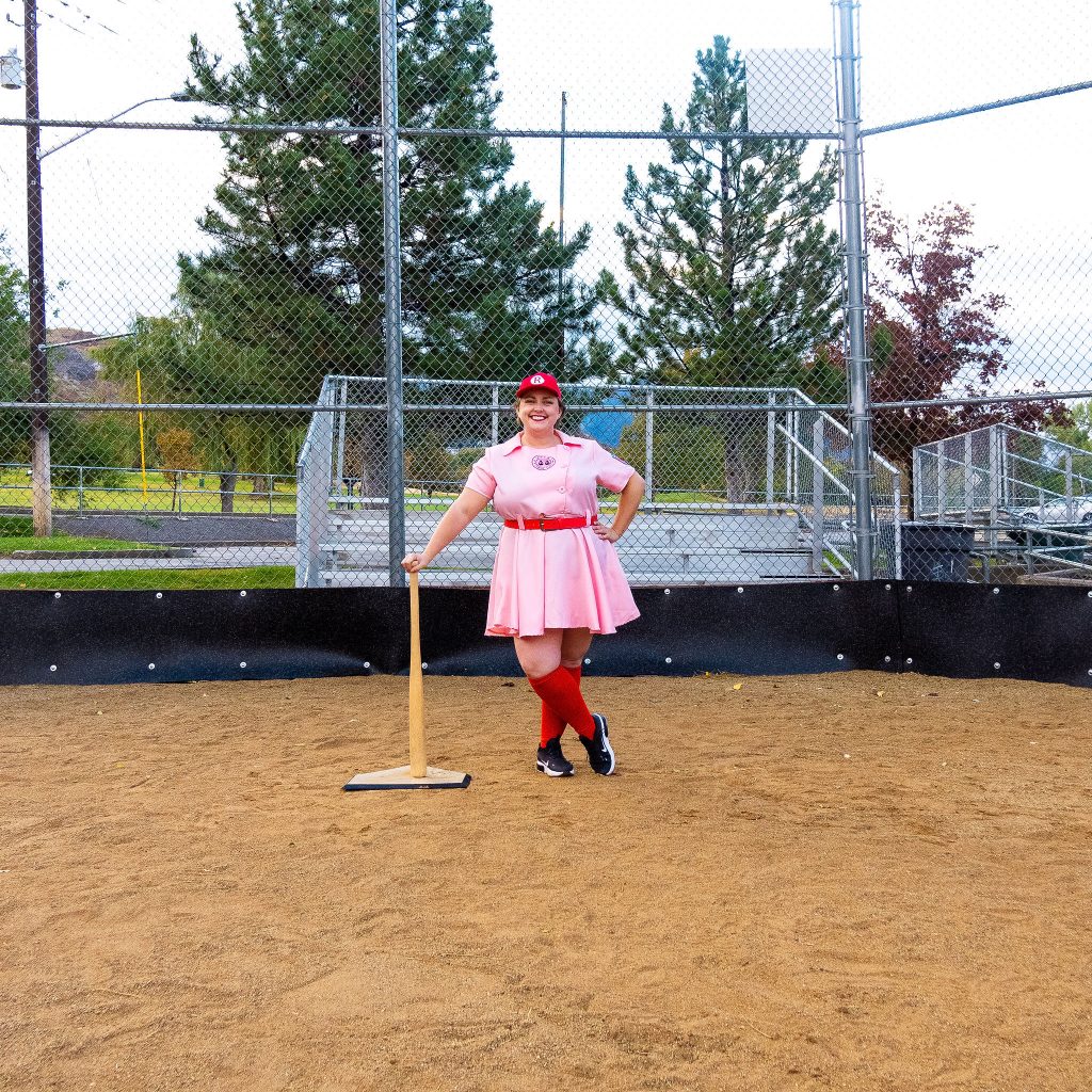 Costume Review - Plus Size a League of Their Own Halloween Costume - pink costume with blogger posing with bat