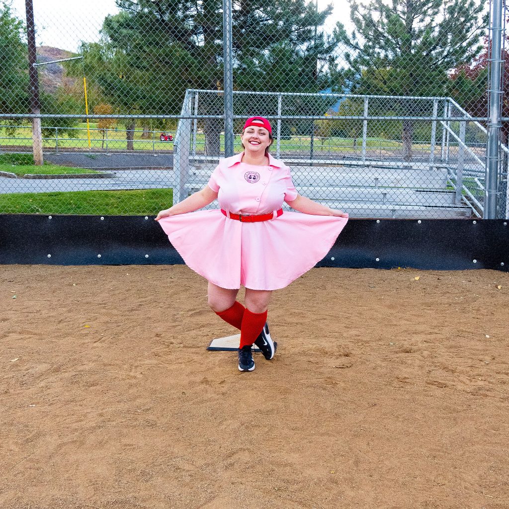 Costume Review - Plus Size a League of Their Own Halloween Costume - blogger posing in pink baseball dress