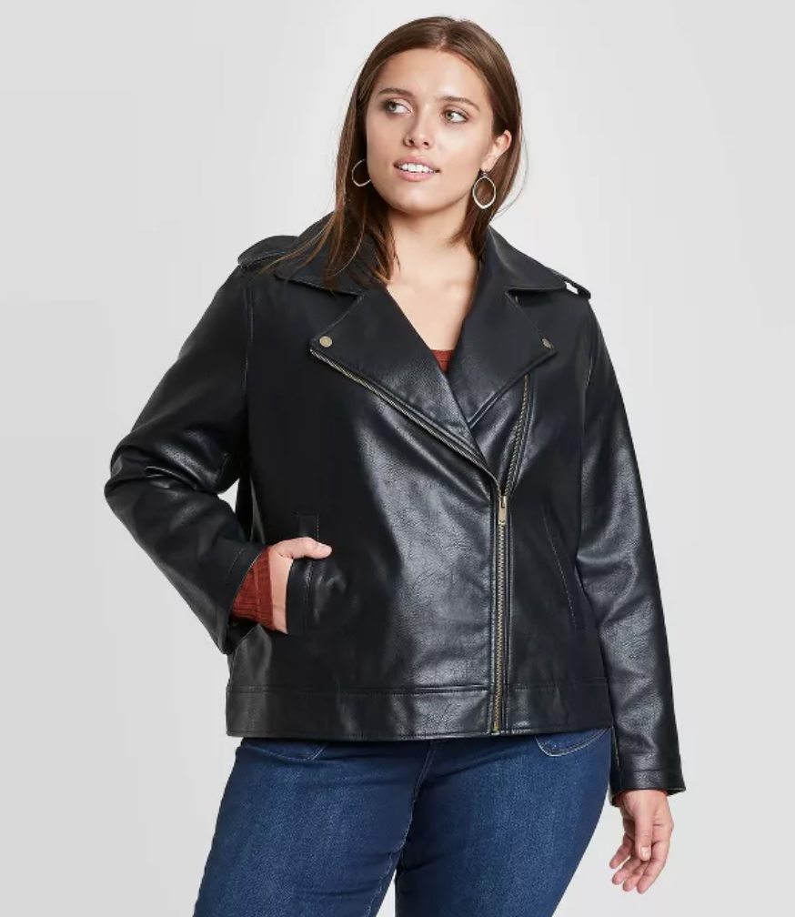 Plus size model wearing plus size black faux leather jacket, moto style