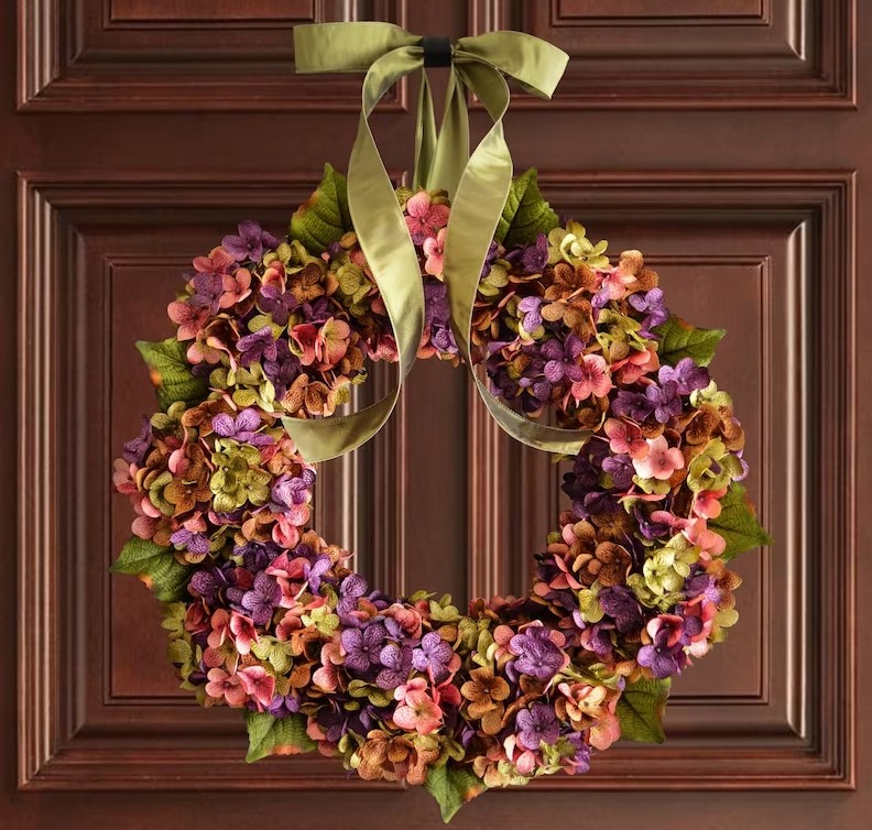 Front Door Wreaths for Summer featuring pink, purple, and orange blossoms with a light sage green door ribbon