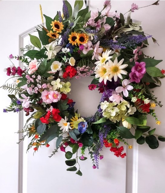 Front Door Wreaths for Summer - rainbow wreath with small yellow sunflowers, white daisies, pink flowers, bright purple flowers, red flowers and assorted greenery that includes eucalyptus leaves