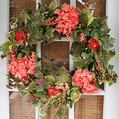 Front Door Wreaths for Summer - red and brigh pink geranium flowers against a variety of green leaves in the background of the wreath