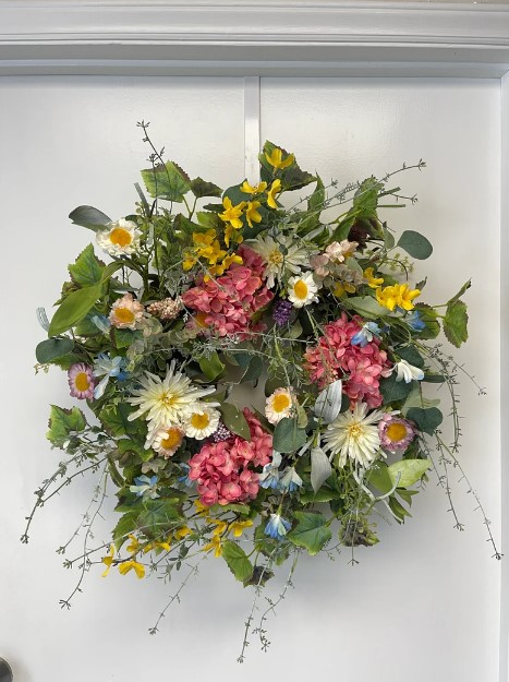 Front Door Wreaths for Summer - wild and overgrown looking fun wreath with yellow flowers, daisies, begonias, leaves and spindly green vine looking faux plants