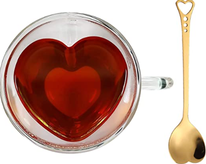 Glass mug with red liquid in it showing the heart shape and a gold color spoon with a heart shaped spoon part and a little heart on the end of the spoon