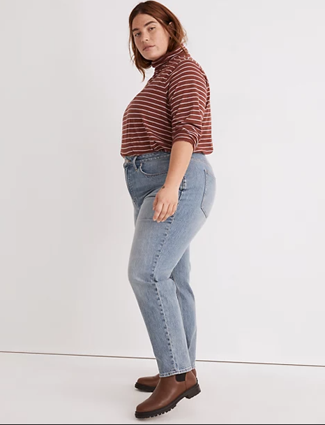 Plus size Masculing Clothing - model modeling a fat outfit featuring a t-shirt with horizontal stripes, high waist blue denim and brown shoes.